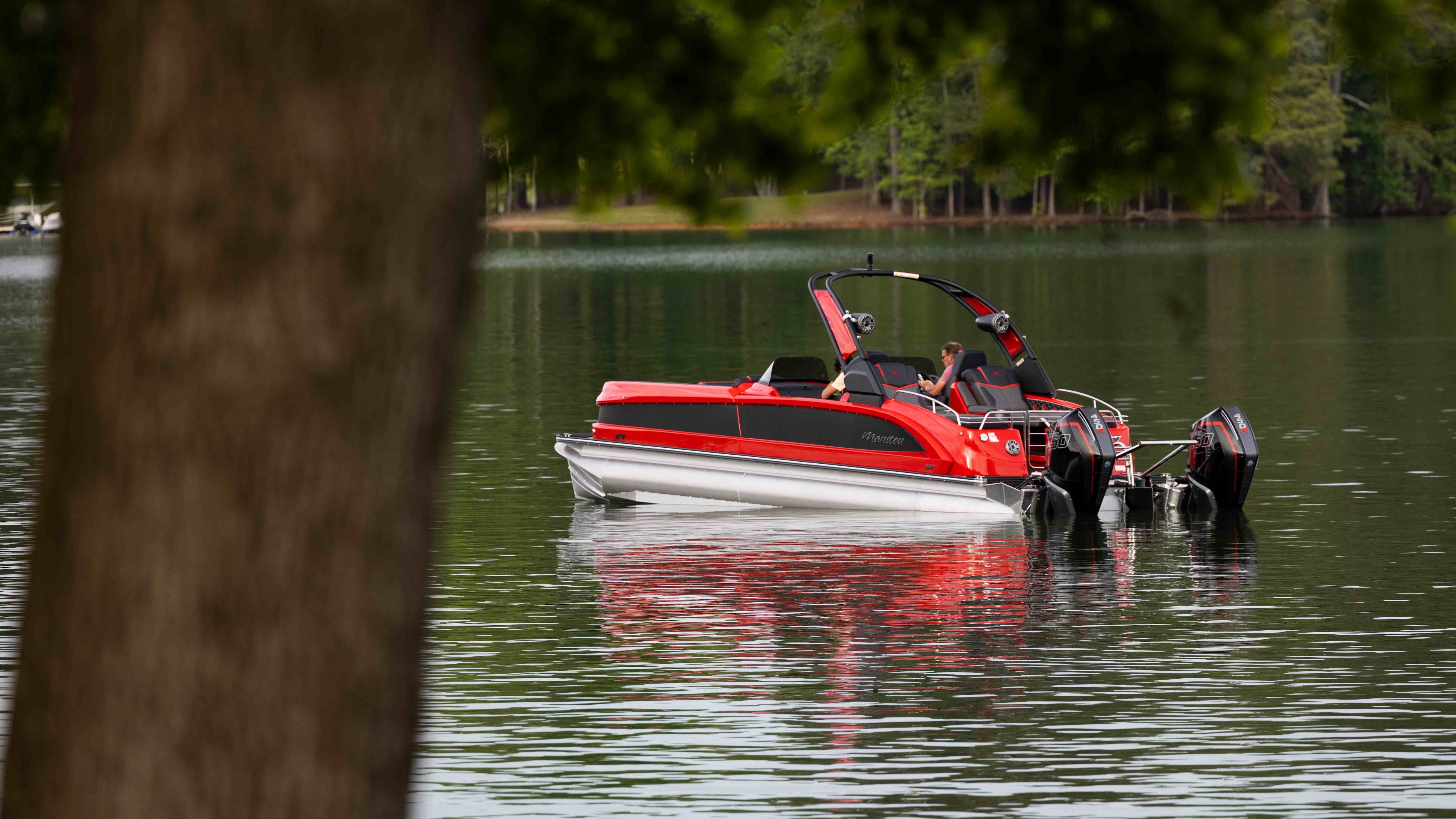 Man enjoying day on Manitou XT dual engine on lake