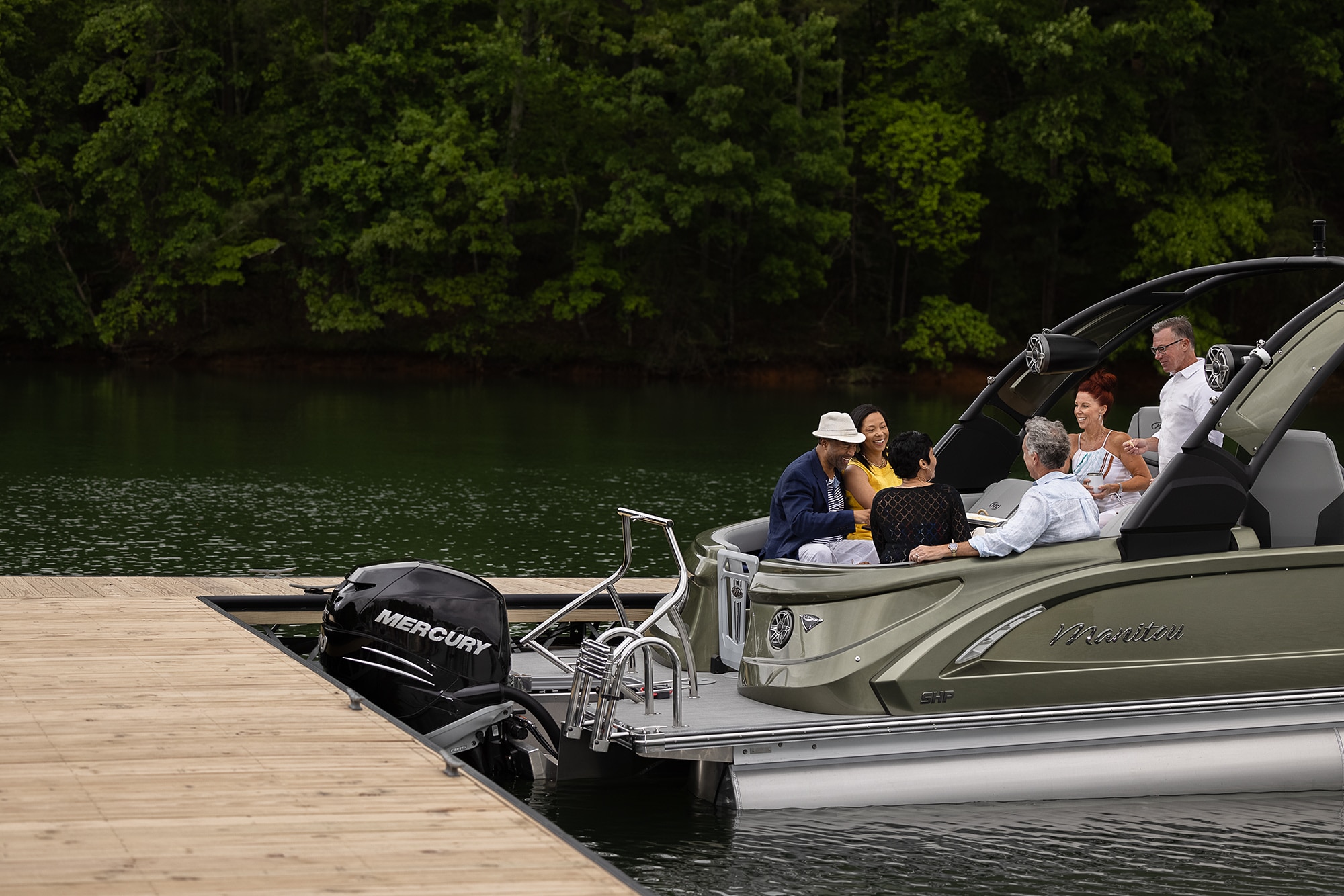 Manitou XT Pontoon Boat docking on a lake