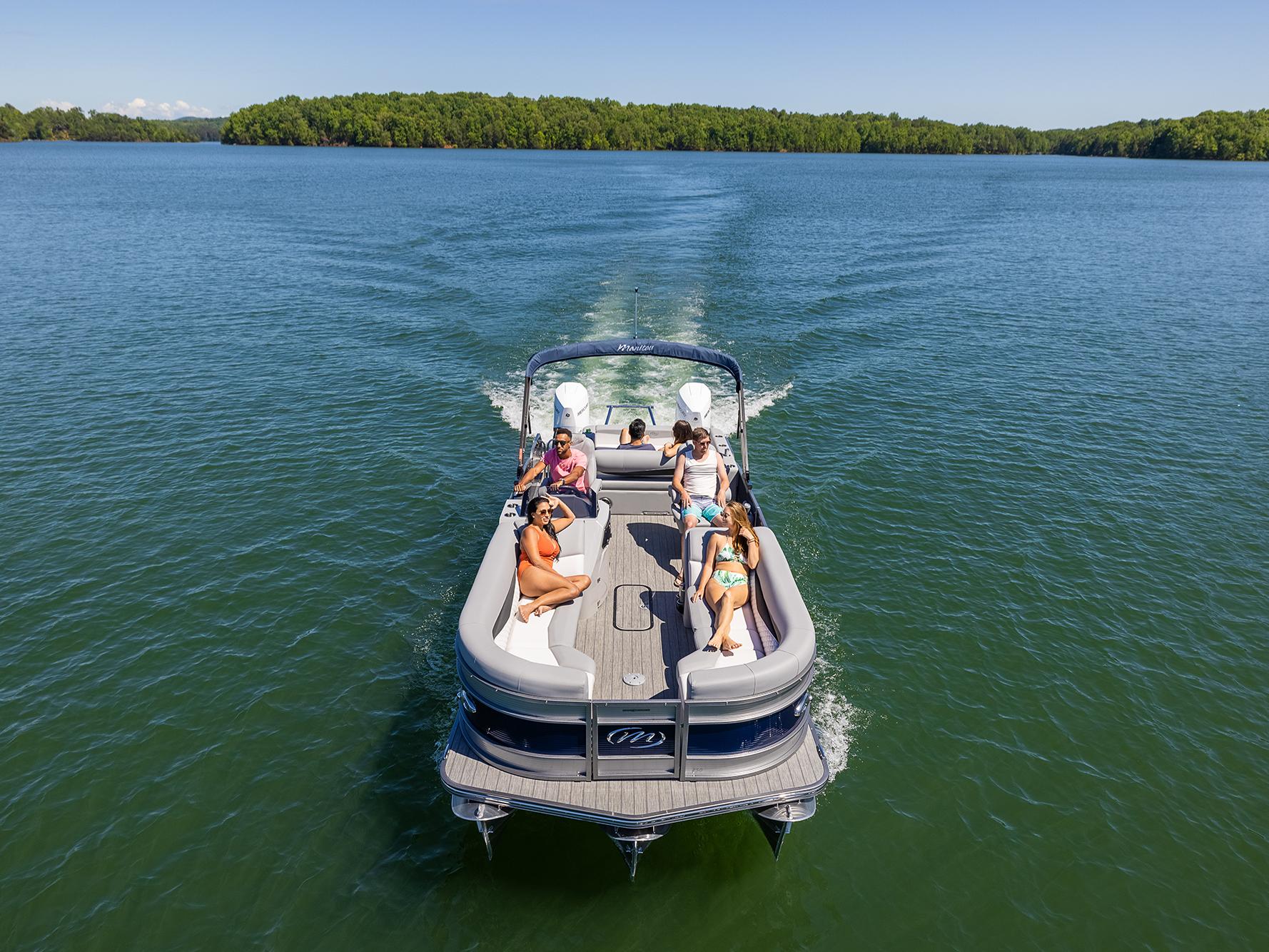 Manitou Recreation Pontoon Boat cruising on a lake