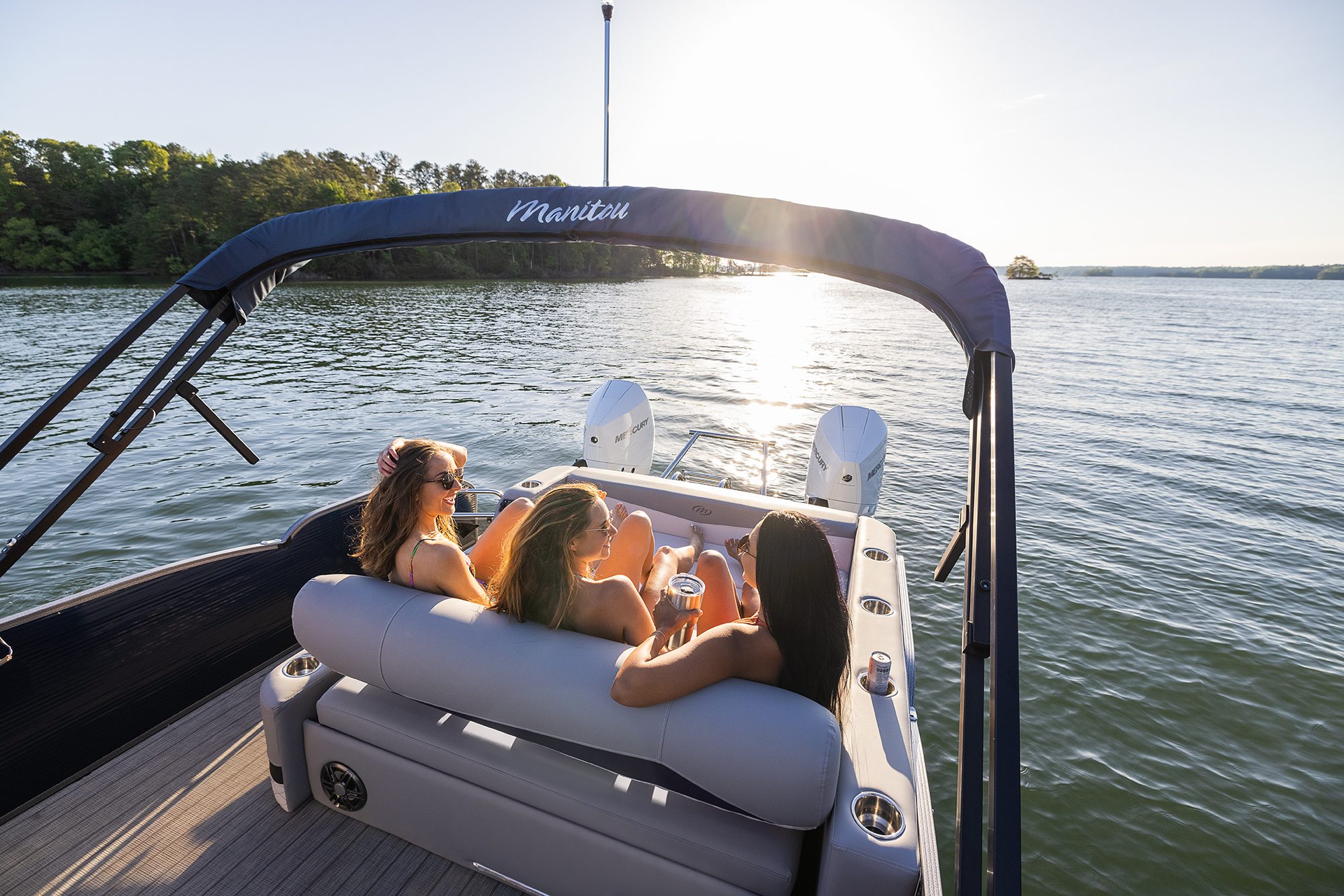 Women lounging on a Manitou Encore Pontoon Boat