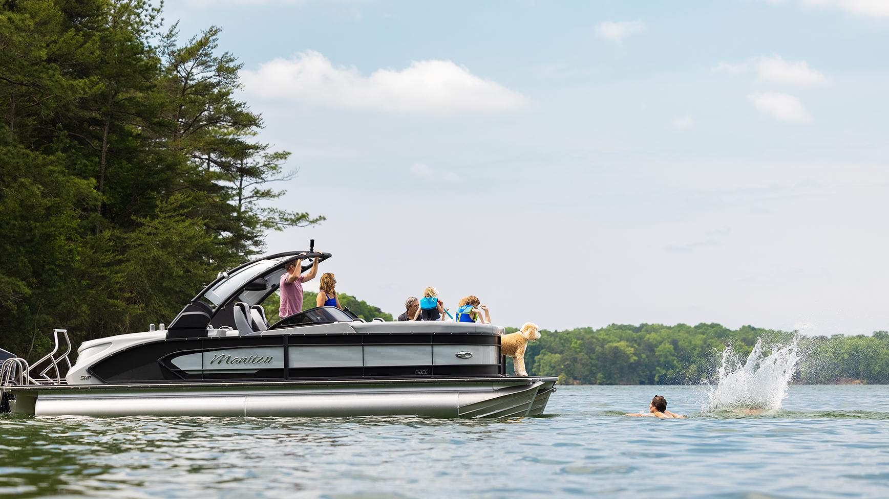 Family enjoying a water moment with their Manitou LX Pontoon Boat