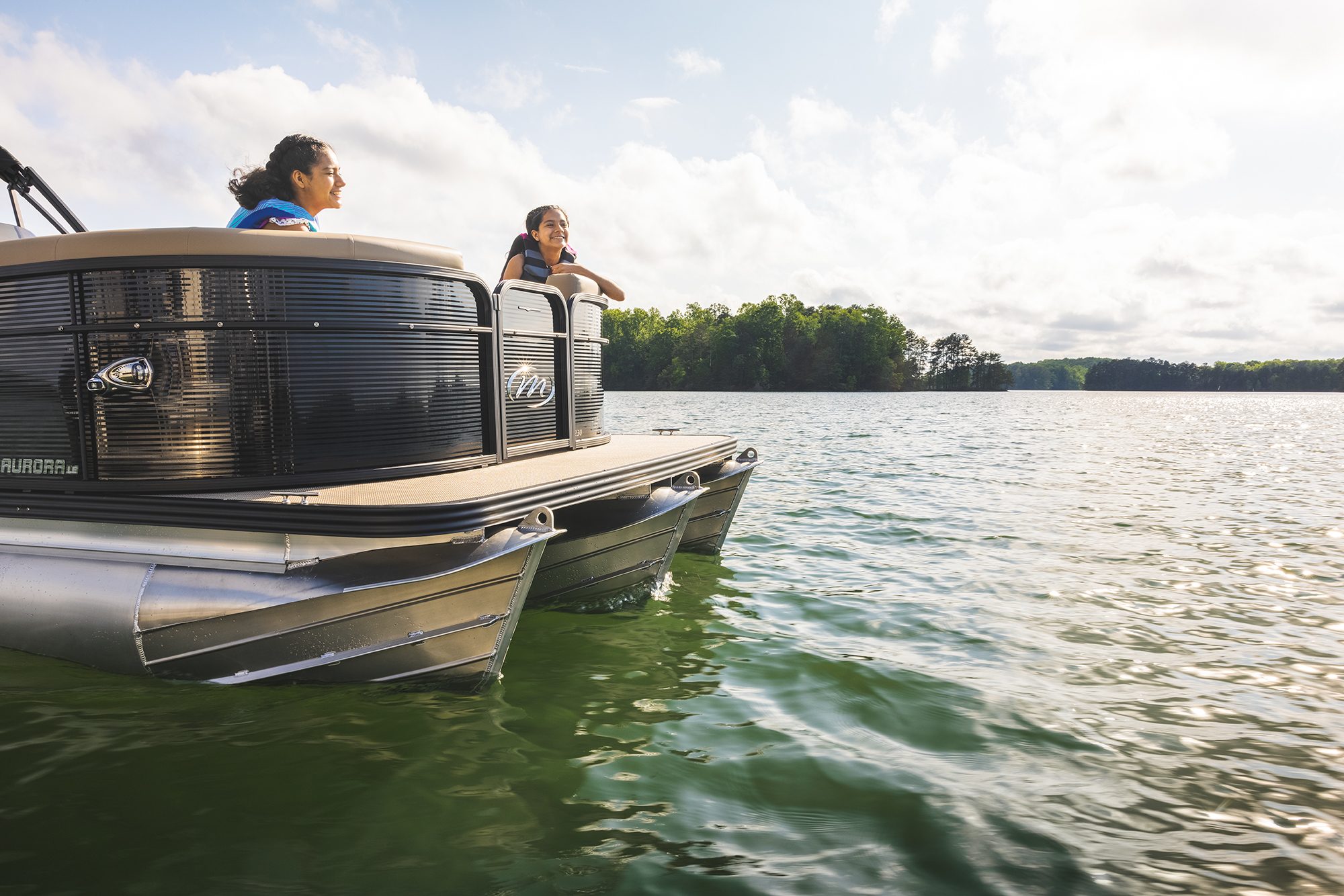 2 girls on a Manitou Aurora LE Pontoon Boat