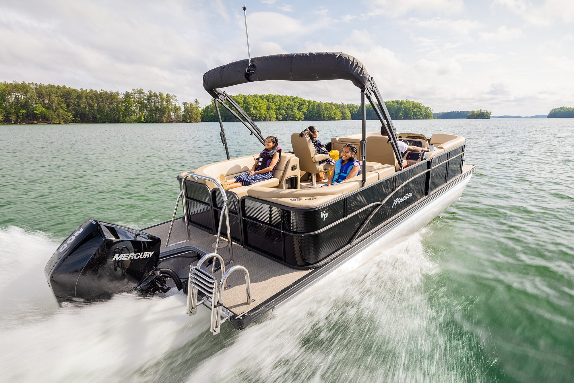 Manitou Aurora LE Pontoon Boat cruising on a lake