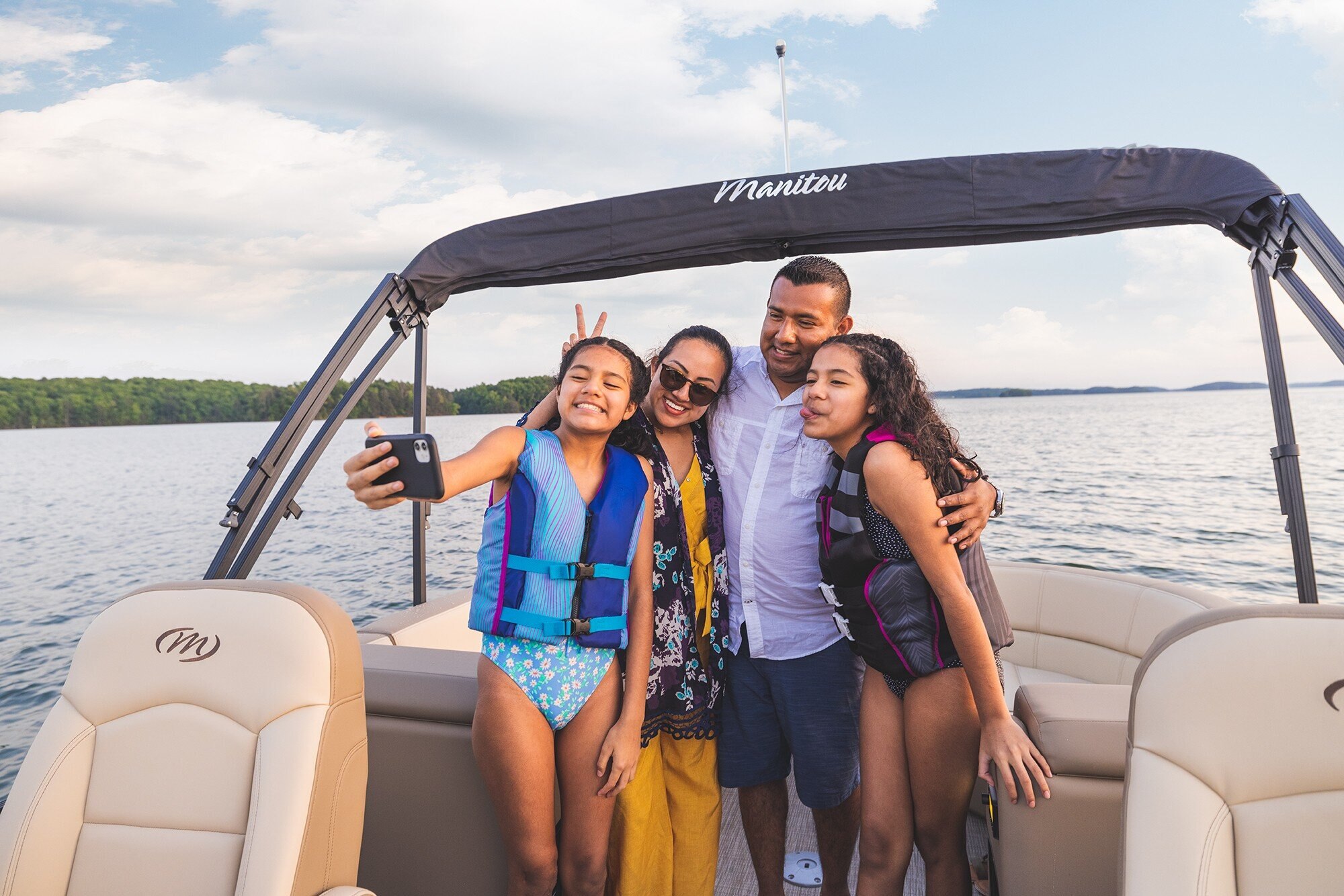 Famille prenant un selfie sur un bateau ponton Manitou Aurora LE