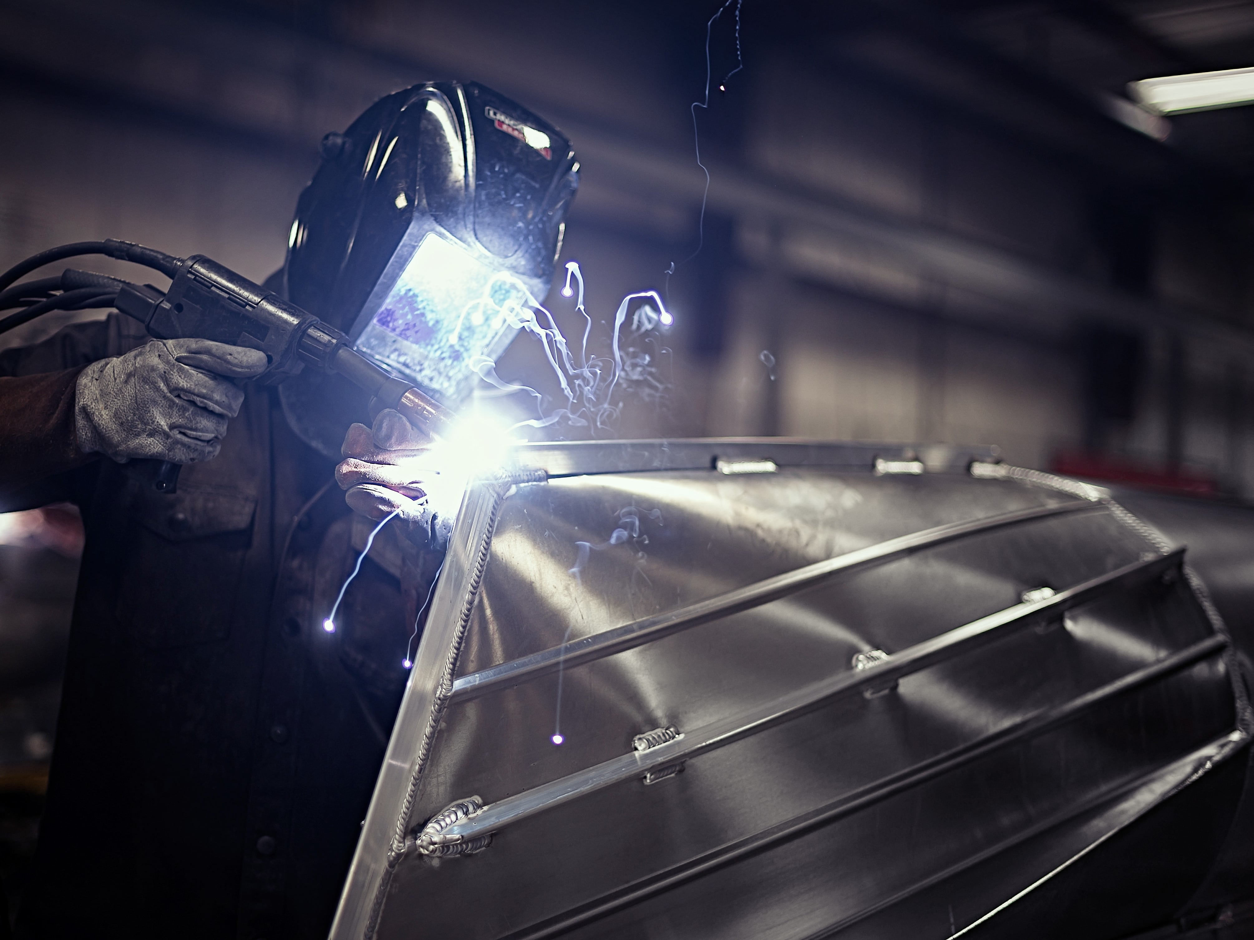 Worker welding a Manitou Pontoon Boat