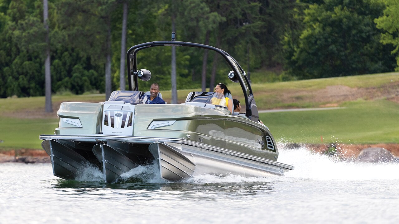 2 people going fast with their Manitou LX Pontoon Boat