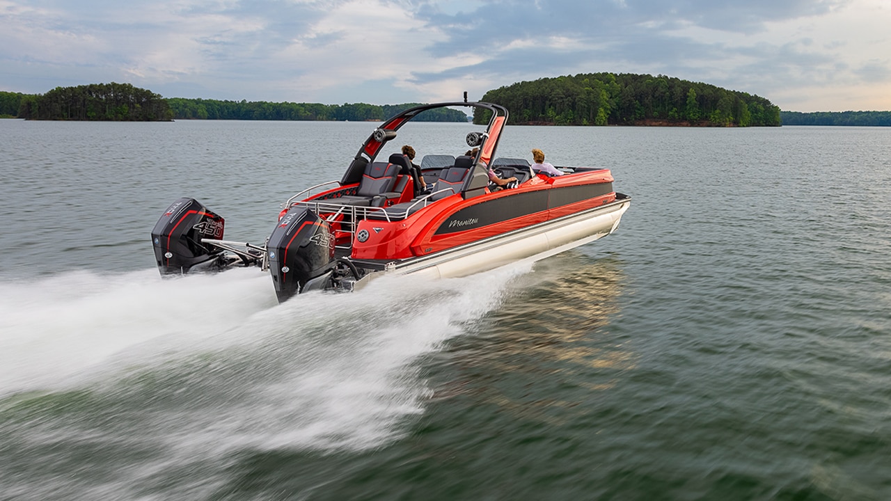 A fast Manitou Pontoon Boat on a lake