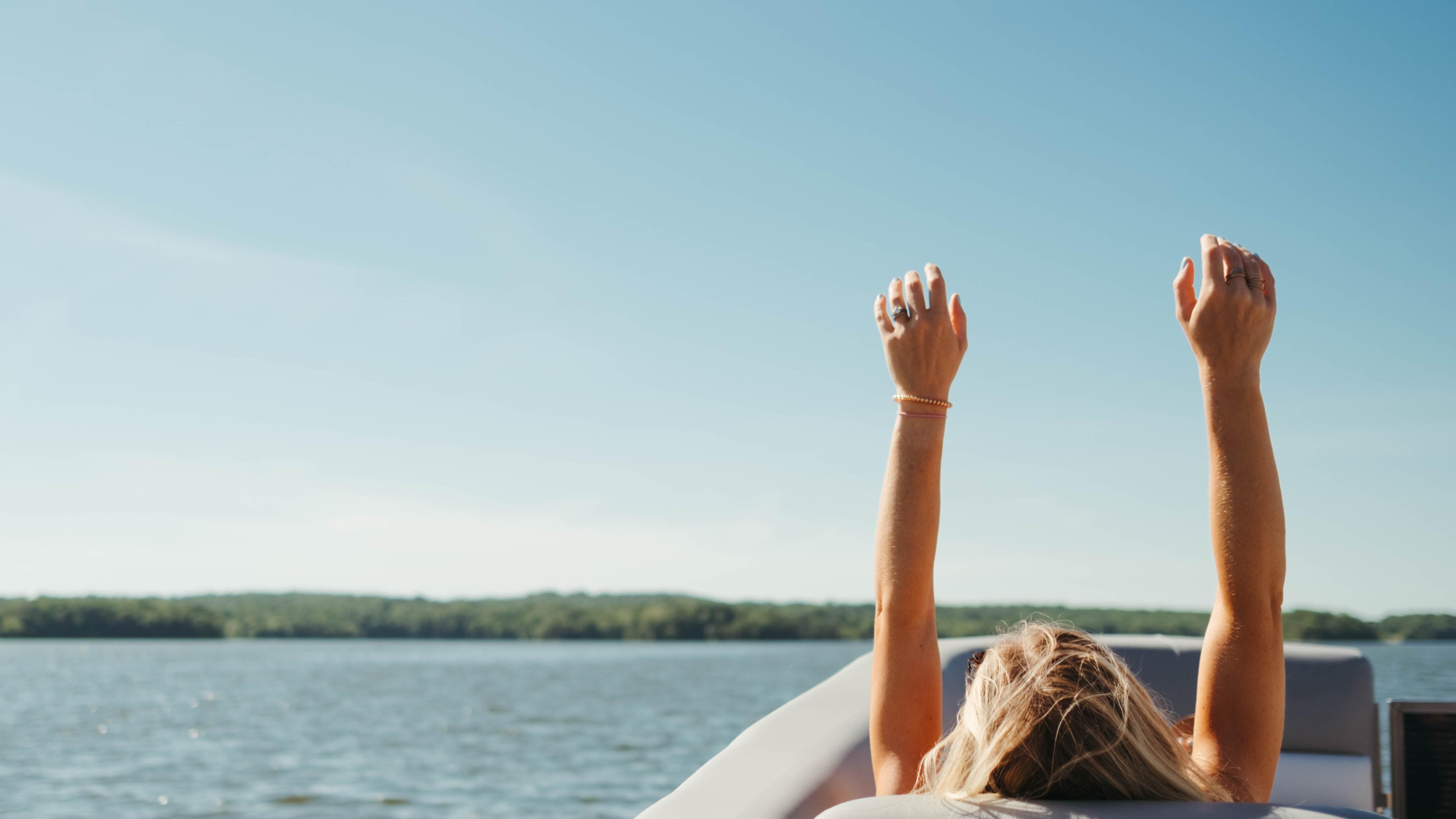 Passenger enjoying a quiet ride on a 2022 Manitou Pontoon Boat