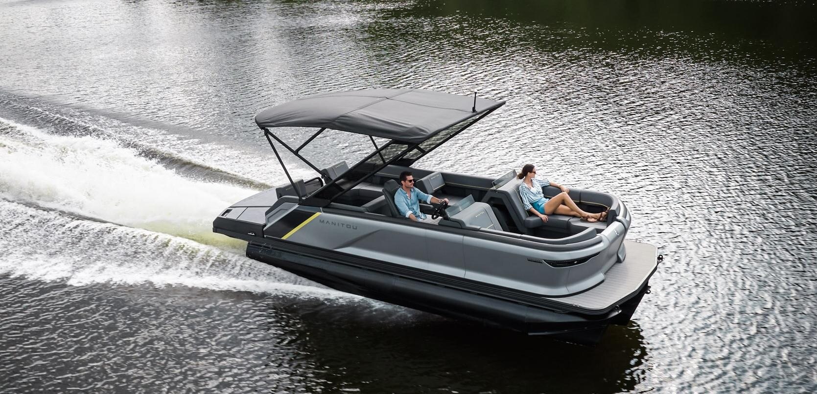 Couple of friends enjoying switchback loungers on the water in Manitou Explore