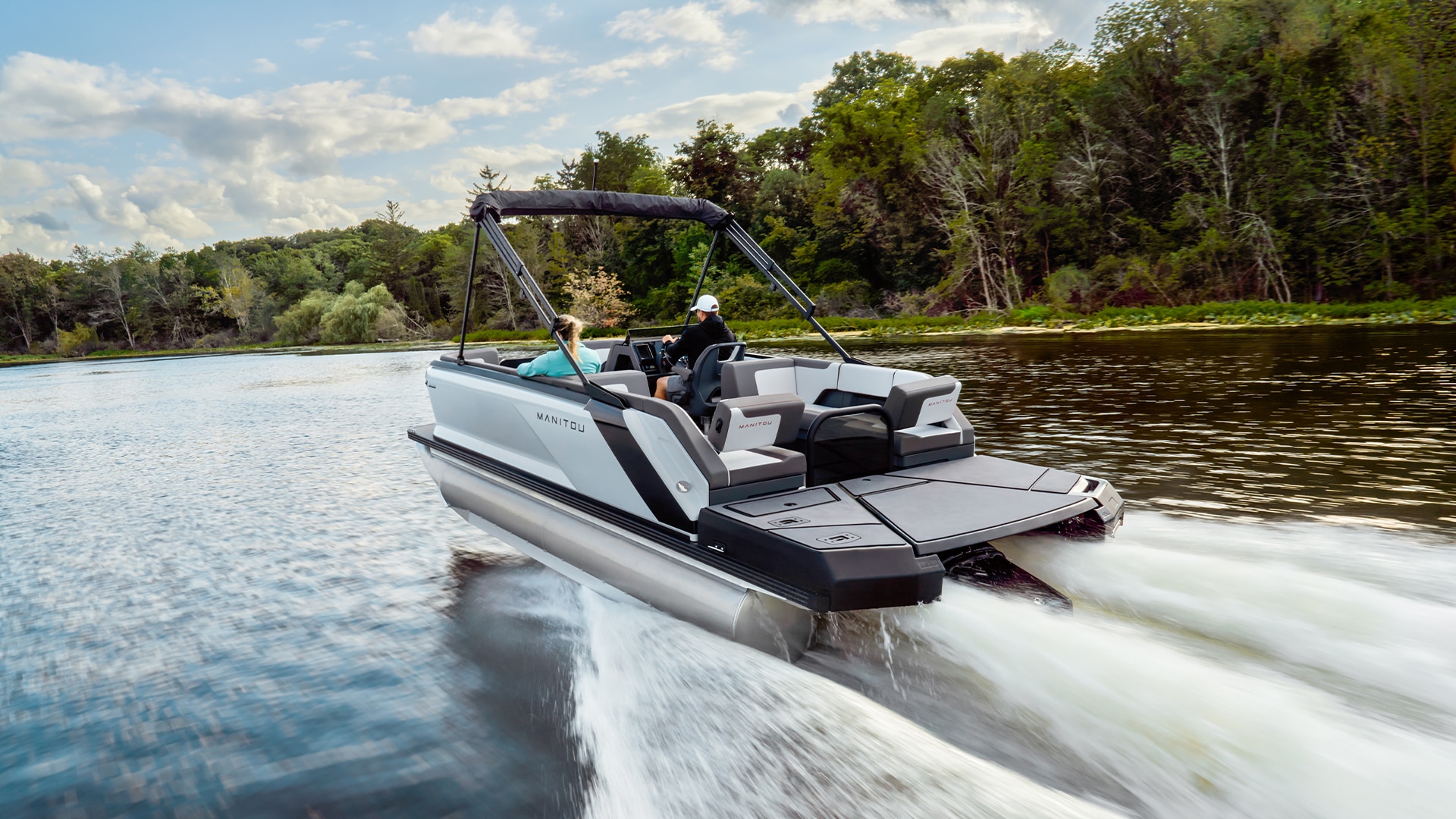 2023 Manitou Explore racing on a lake