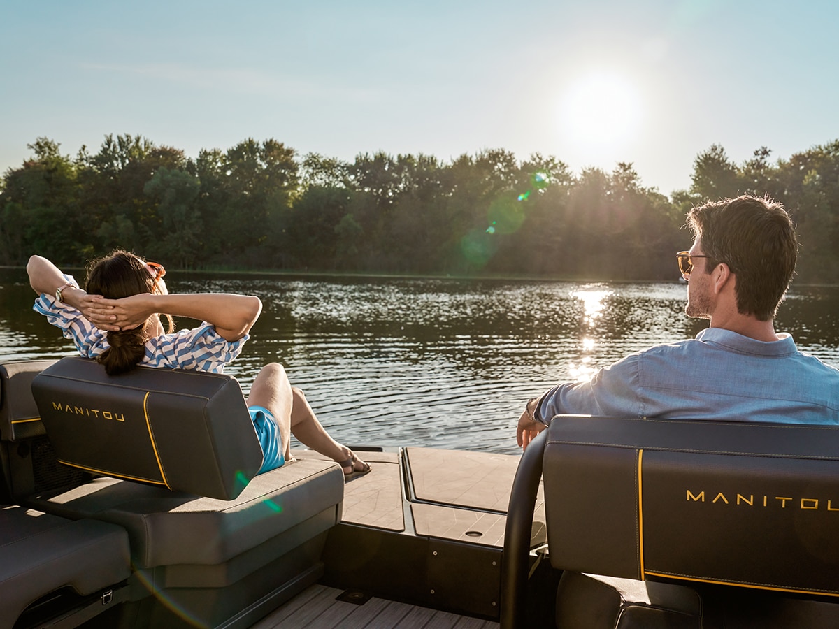 Couple enjoying the sunlight on a 2023 Manitou Explore