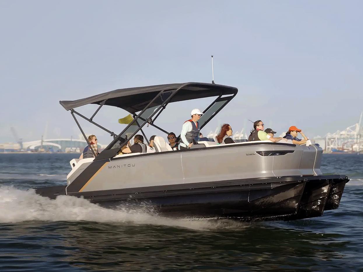 Group of people riding in a Manitou pontoon boat