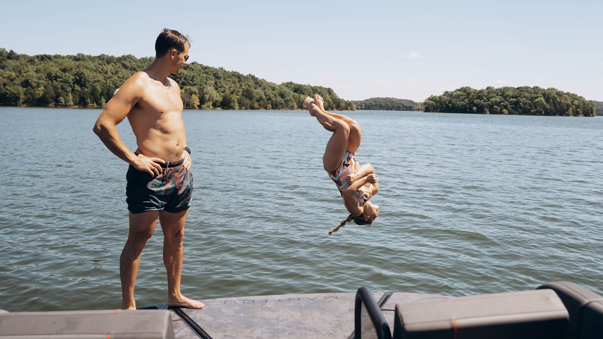 Shawn Johnson jumping from the Max Deck of her Manitou pontoon
