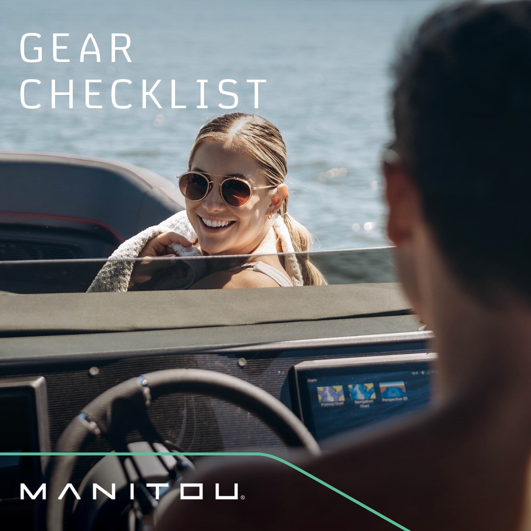 Women smiling at the driver at the helm of the Manitou Explore