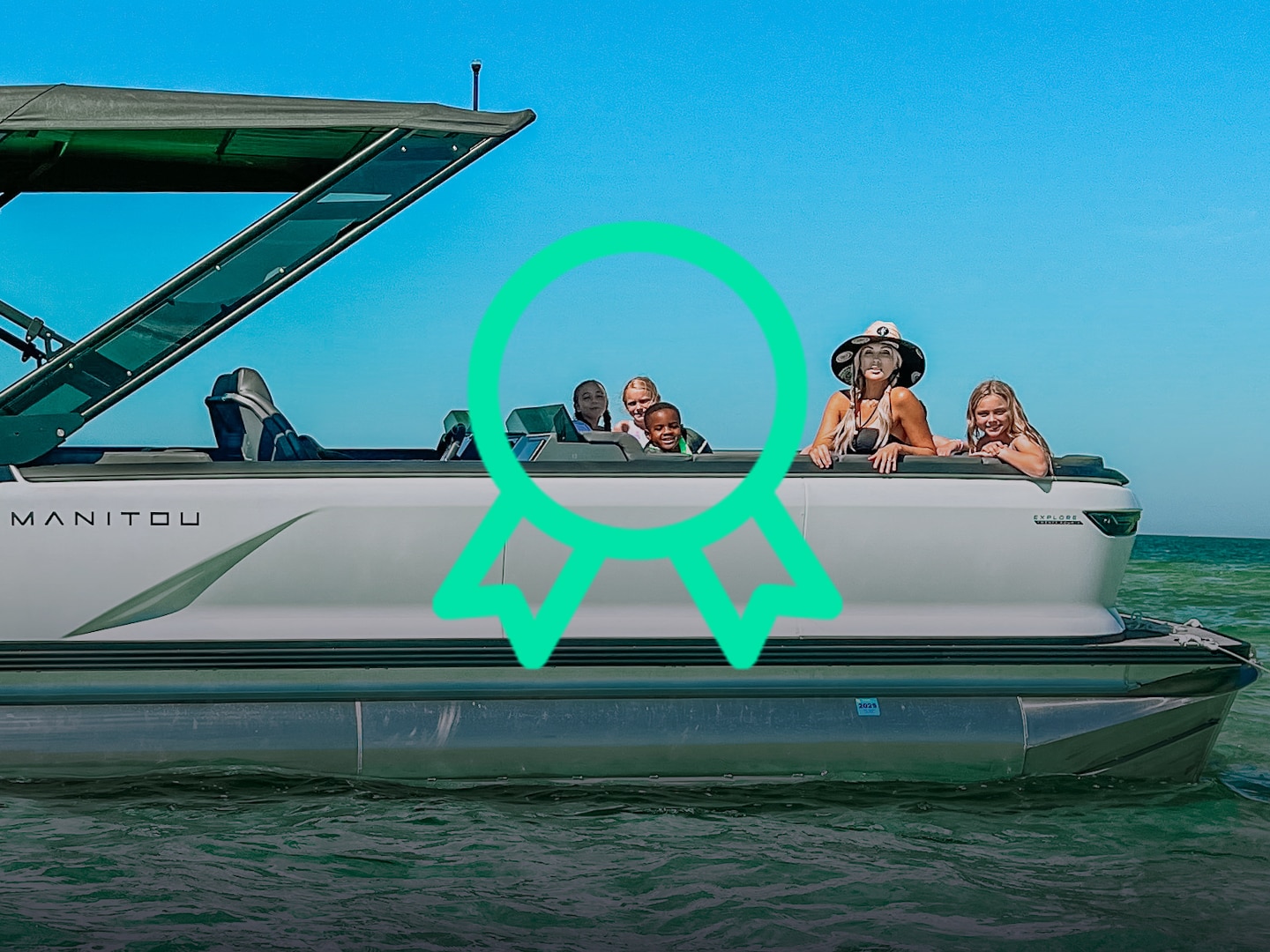 Smiling family enjoying a day under the sun in an idiling Manitou pontoon boat