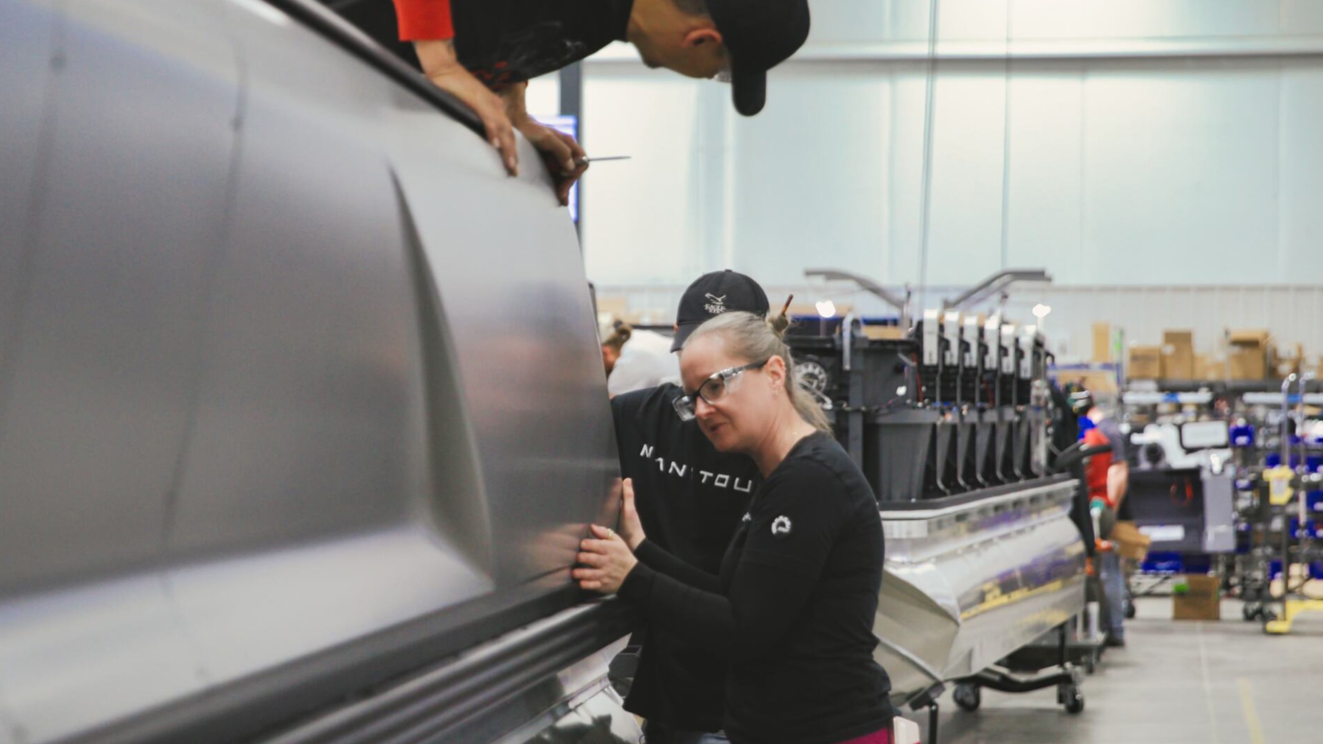 Manitou workers building an Explore model