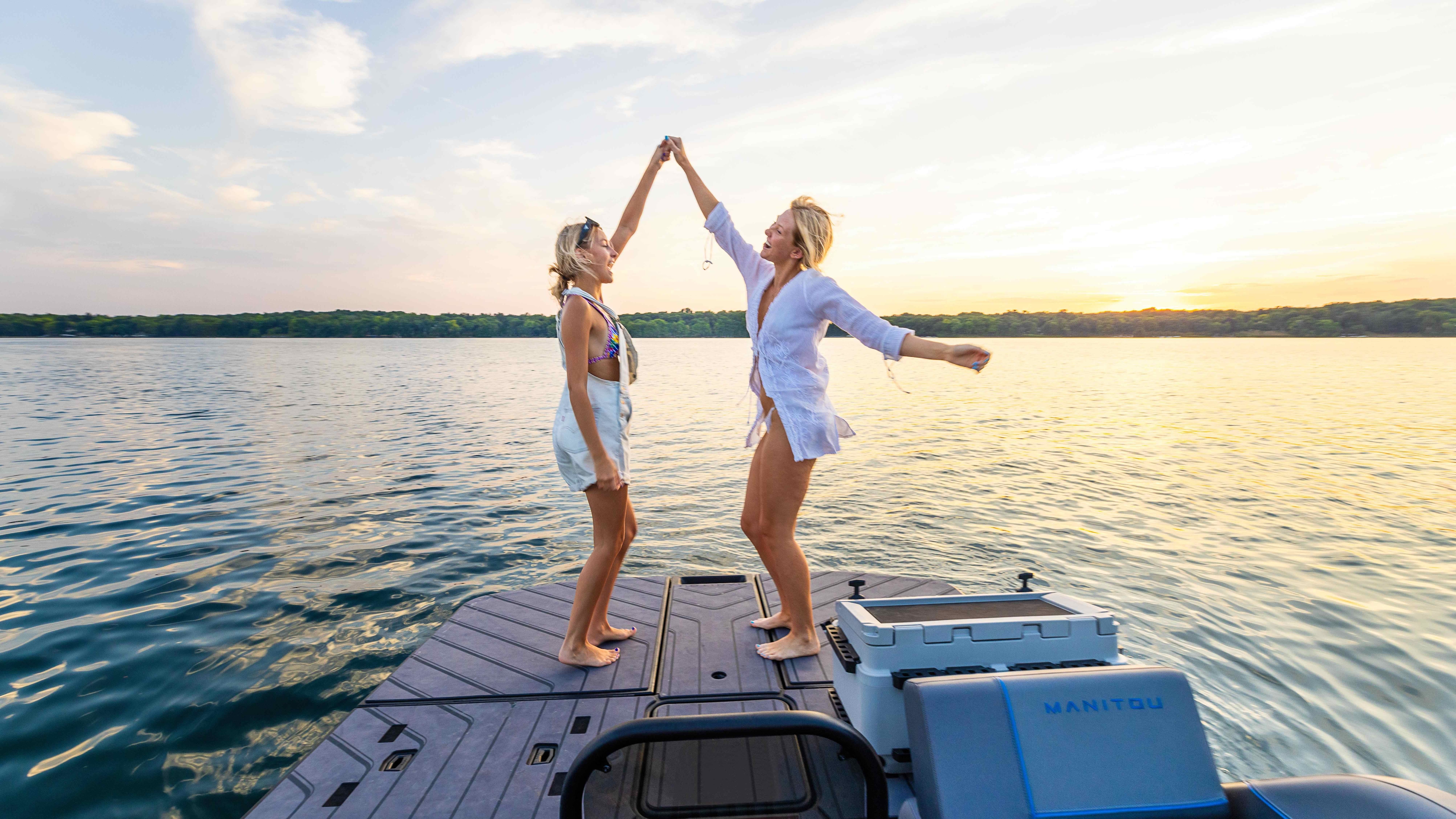 Two friends dancing on the Manitou Explore Switchback's MAX Deck platform