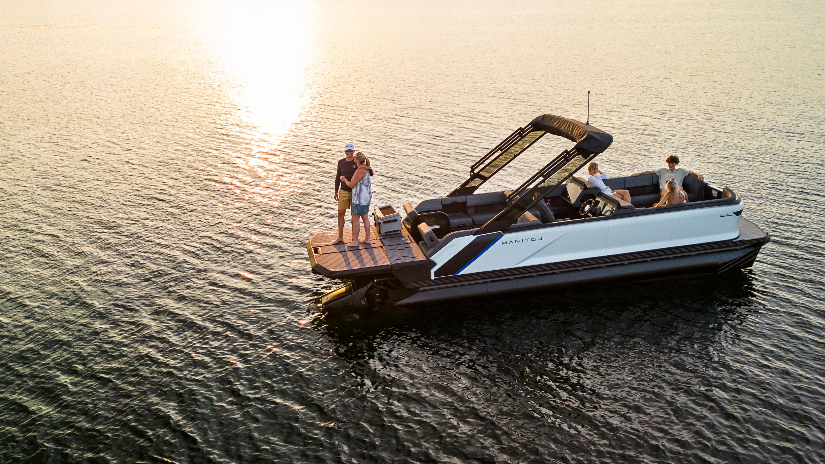 Friends enjoying the sunset an on idle 2024 Manitou Explore Dual Engine pontoon