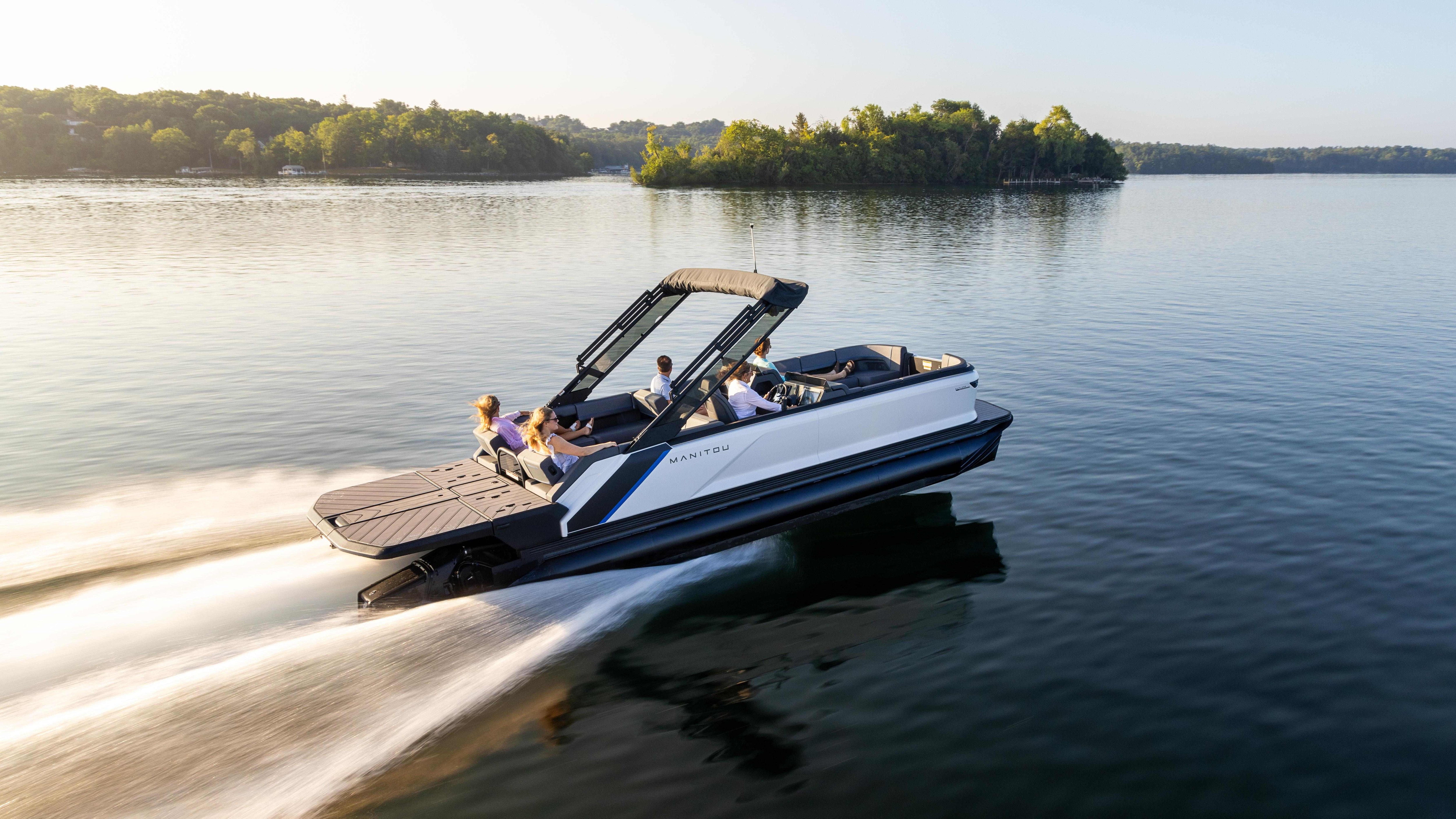 Friends cruising on a lake on a Manitou Explore MAX with Dual Rotax S 150