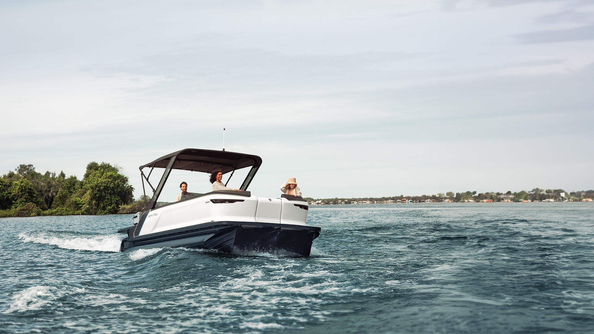 Manitou Explore 2024 bateau pontoon avec Sport Bimini top en croisière sur un lac