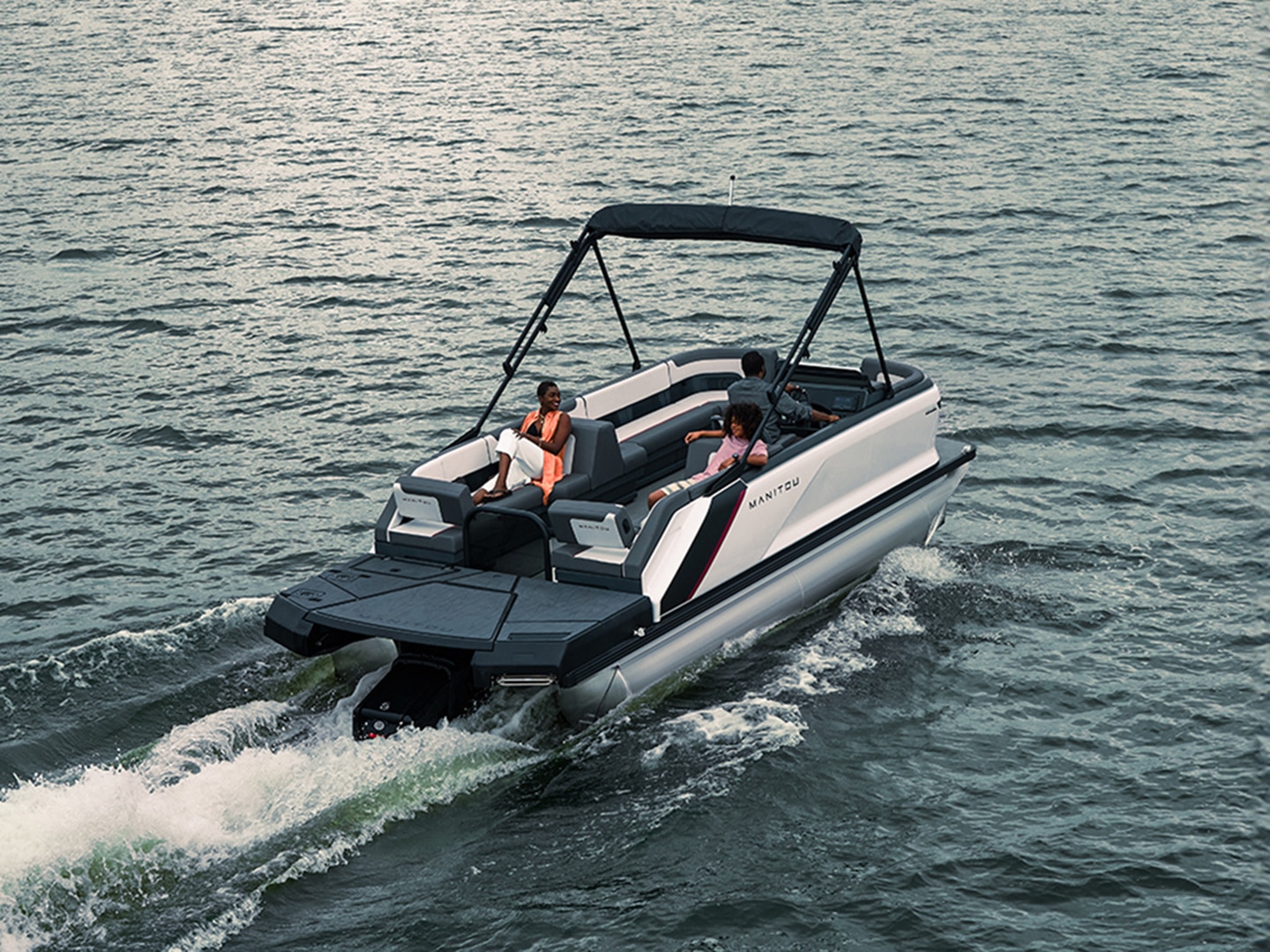 A family sailing on a Manitou Cruise 2024 with a Rotax S150 engine.