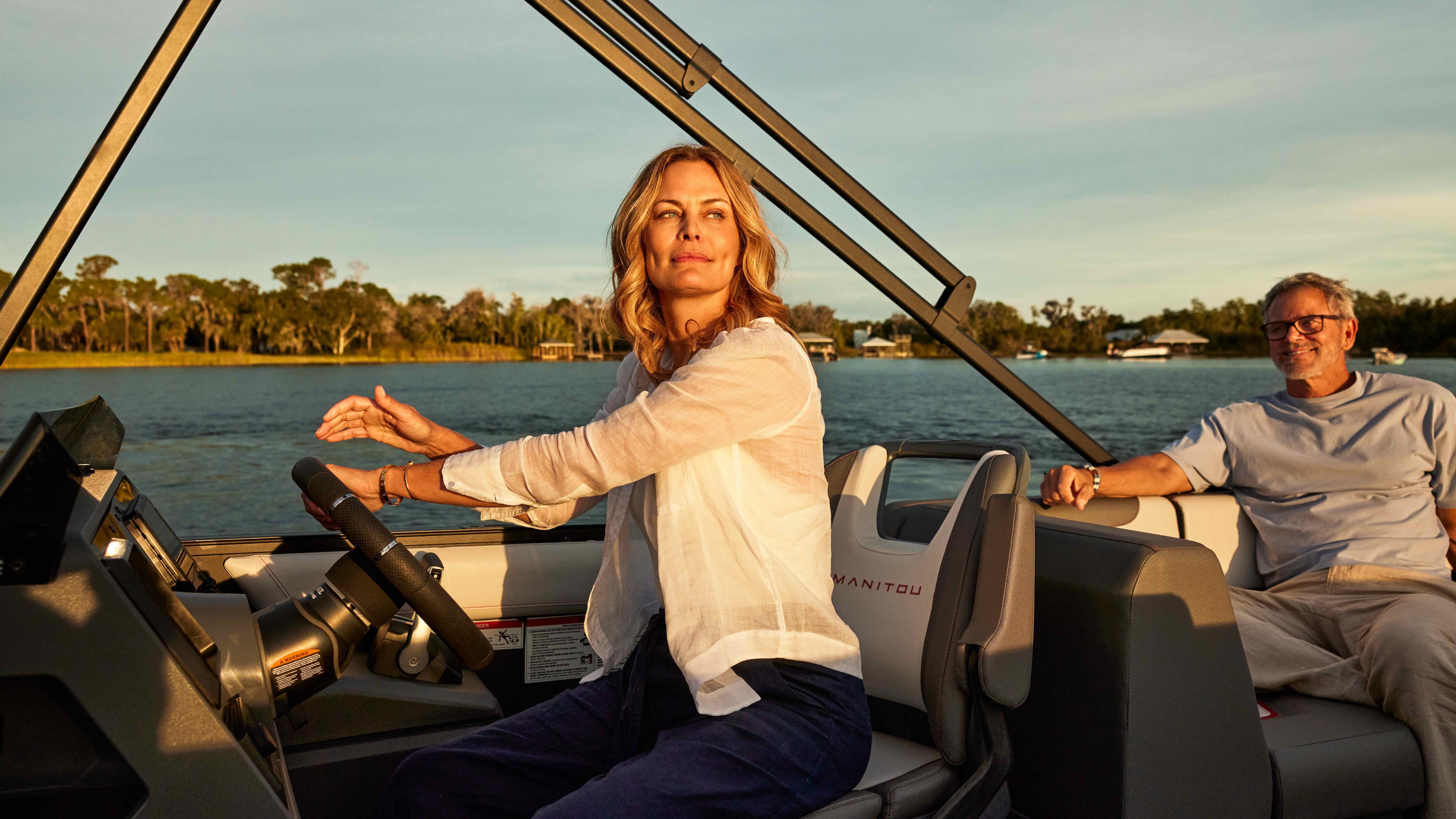 A woman behind the wheel of her Manitou Explore 2024 at sunset